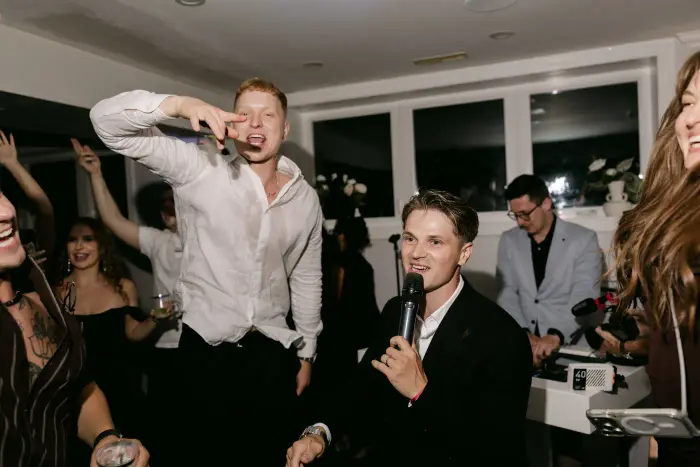 Guests singing into the microphone
