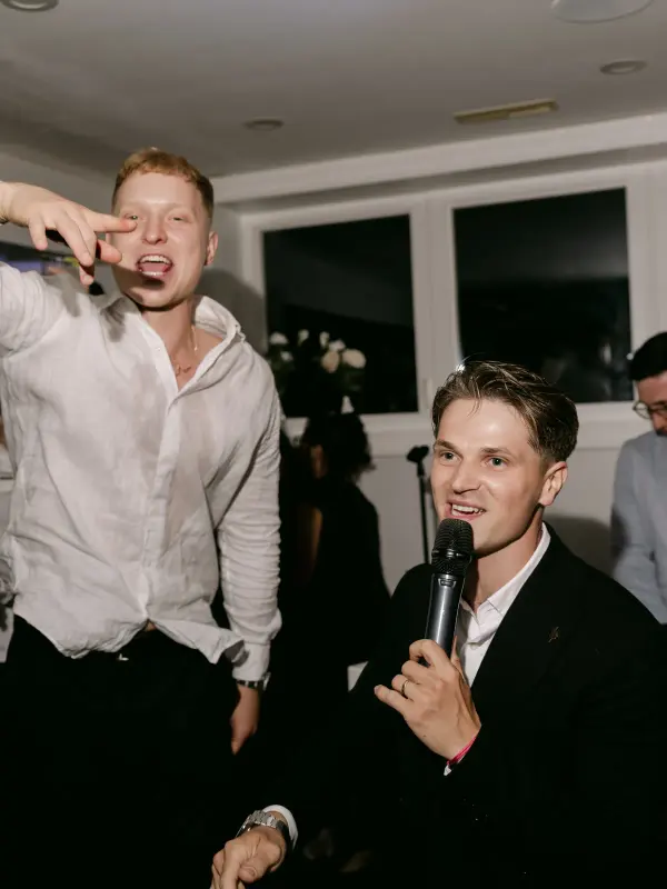 Guests singing into the microphone at a house party