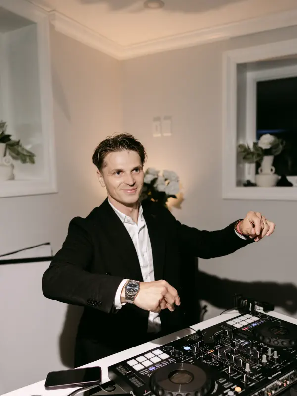 Vladyslav at the DJ controller in a white room